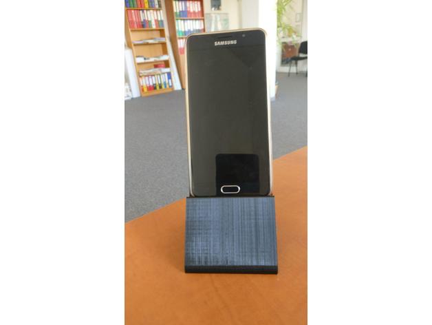 Phone stand with charging calbel slot