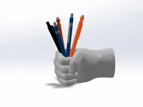 Hand holding pens, pen cup